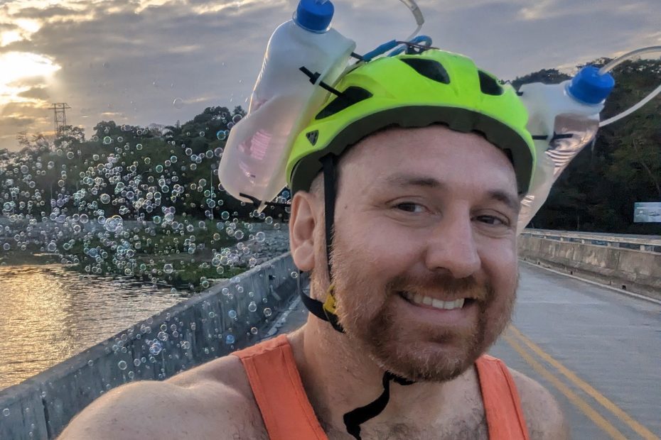 Dr Andy Quitmeyer producing bubbles as he rides a bicycle